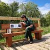 Closeup of person sitting on Heavy Duty Audio Bench at Curraghs Wildlife Park (square)