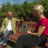 Two people sitting on Echo Point Audio Bench (square)